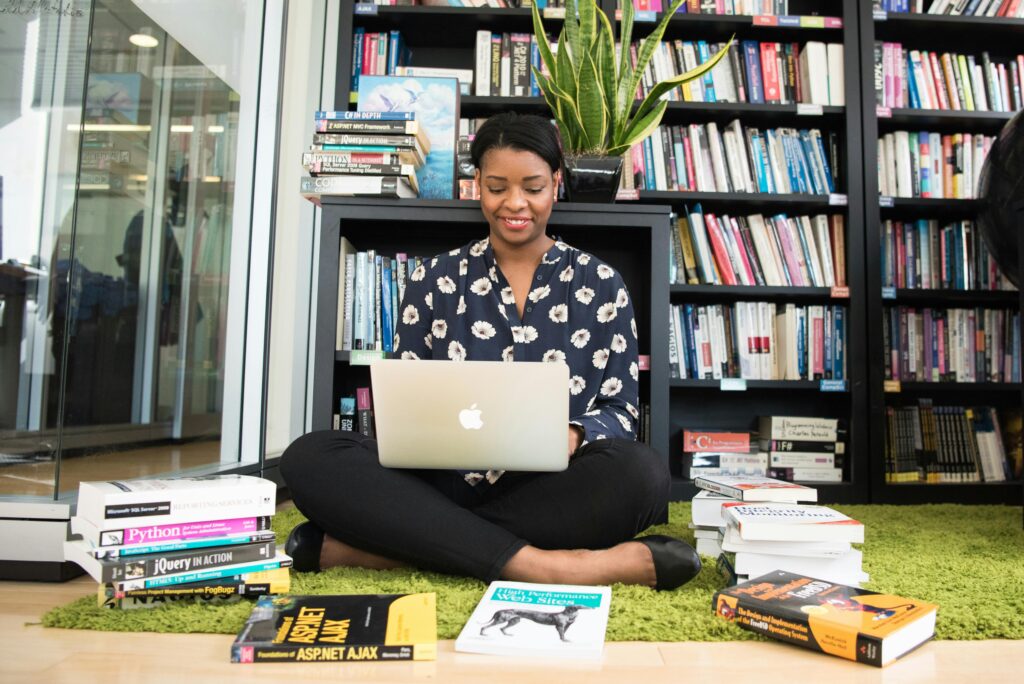 Female college student in Black Shirt Using Macbook