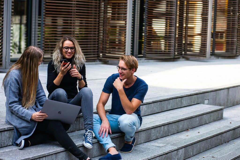 Group of students sitting on the staircase and talking