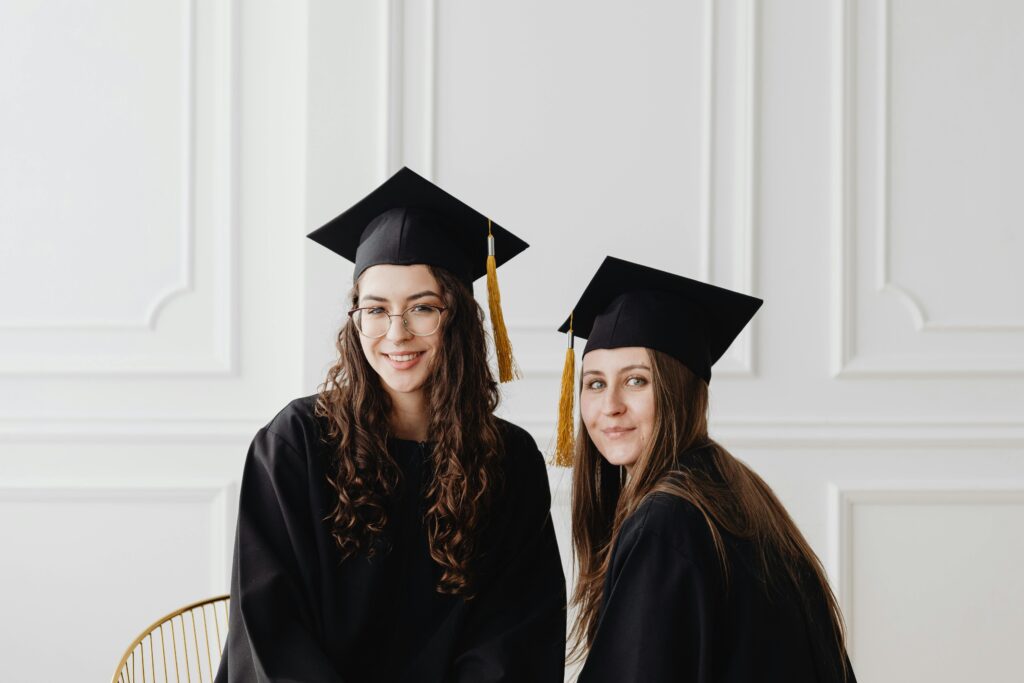 Young Graduates in Their Academic Dress and Graduate Caps